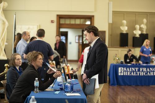 A student talks to a prospective employer