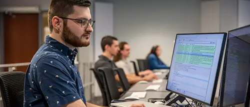 a SEMO student sits at a computer in a lab and works on a project