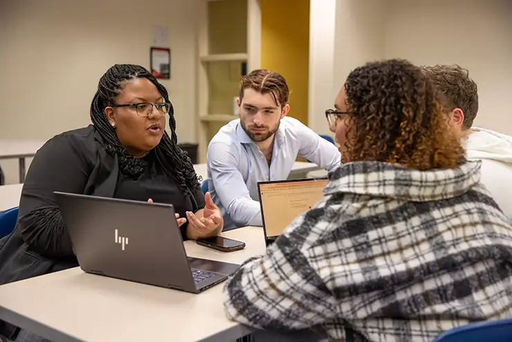 a group of SEMO students sit together around a table having a discussion