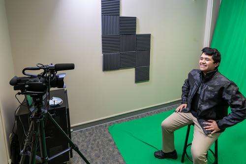 A student films a green screen sequence at The EDvolution Center.