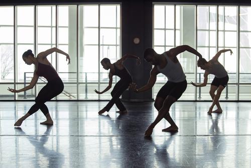 Dancers practice modern dance in a practice room at the River Campus.