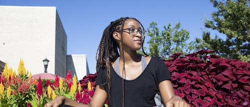 A student studies outside in front of Kent Library.