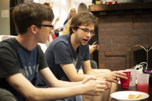 Two students talk over snacks at the Honors Picnic.