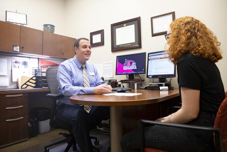 A student meets with her academic advisor. 