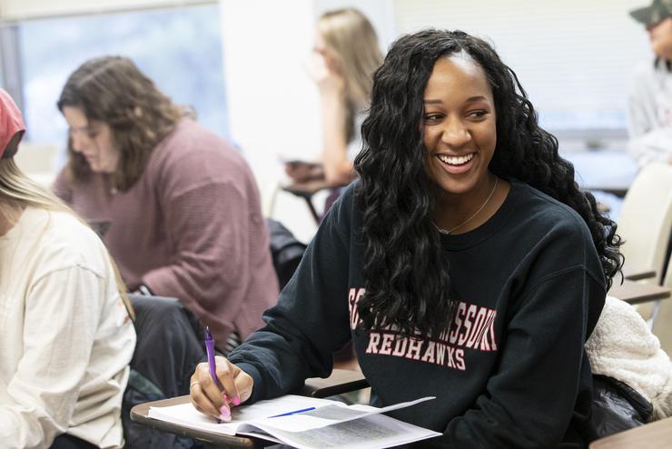 A semo student smiles at her classmate during their Trauma Crisis Intervention class. 