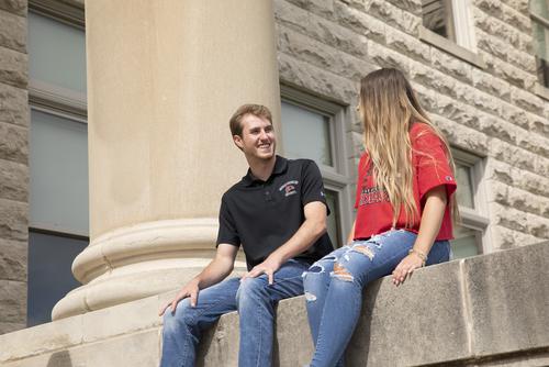 Students study outside of Rhodes Hall. 