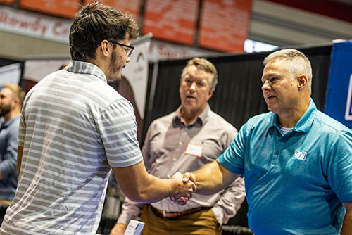 a student speaks and shakes hands with a hiring manager at the SEMO Career Expo