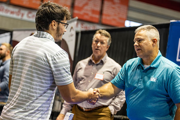 a student speaks and shakes hands with a hiring manager at the SEMO Career Expo