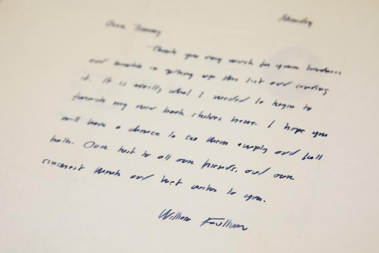 William Faulkner's name is seen at the bottom of a hand-written letter.