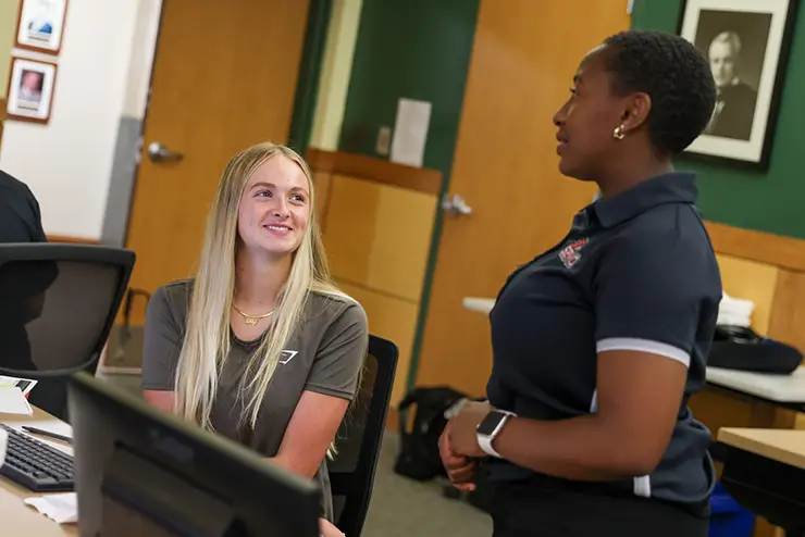 a new student and her advisor talk together during First step to get the student registered for classes