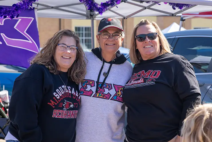 three semo greek life alumni pose together for a photo at the homecoming tailgate
