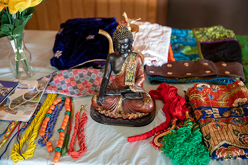 A table of fabrics and a Buddha statue during international week.