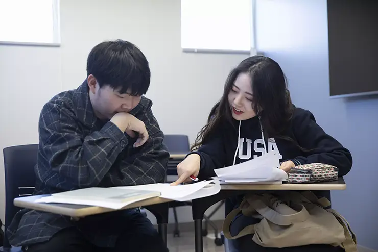 two intensive english program students study together in class