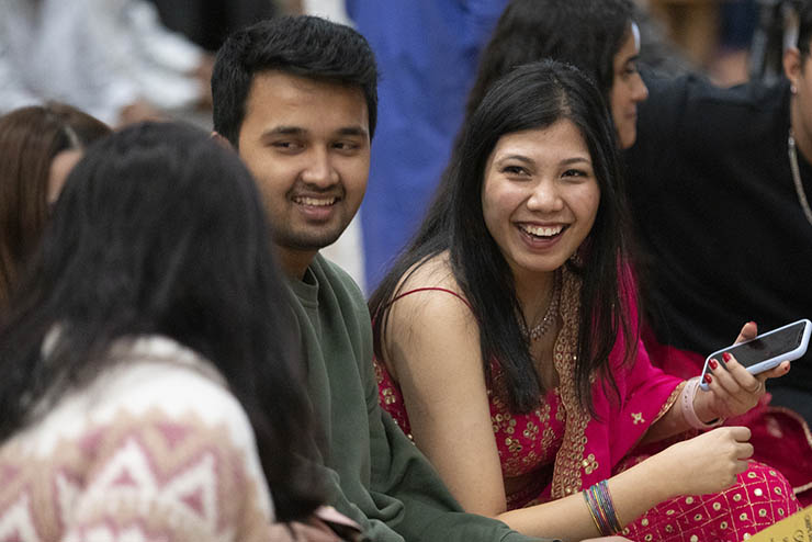 three international students attending Southeast Missouri State University sit together and talk during an event