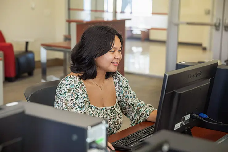 a SEMO international students sit at a workstation in a computer lab