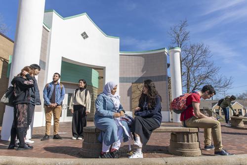 International students sitting outside of International Village