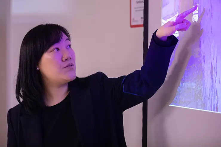 an instructor points to a spot on her projected slide