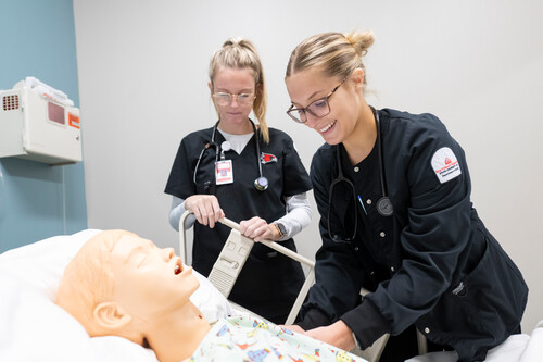 nursing program students using innovative test healthcare patient device to complete hands on learning