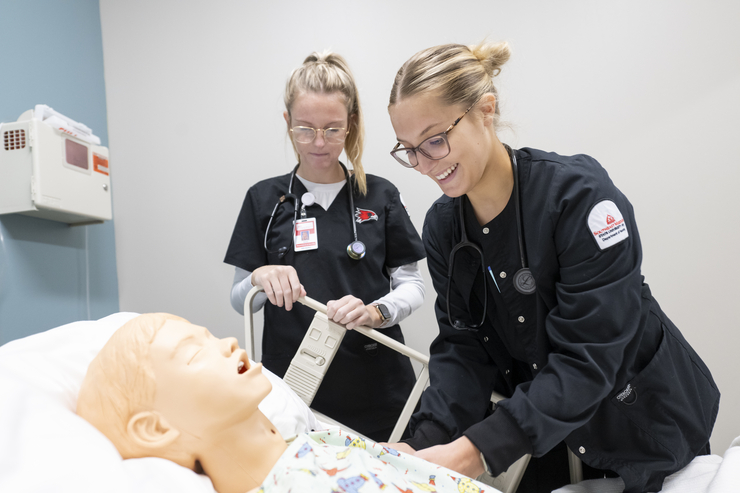 nursing program students using innovative test healthcare patient device to complete hands on learning