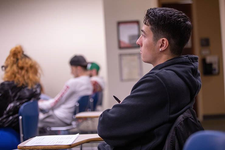 Student learning about criminal justice in a classroom.