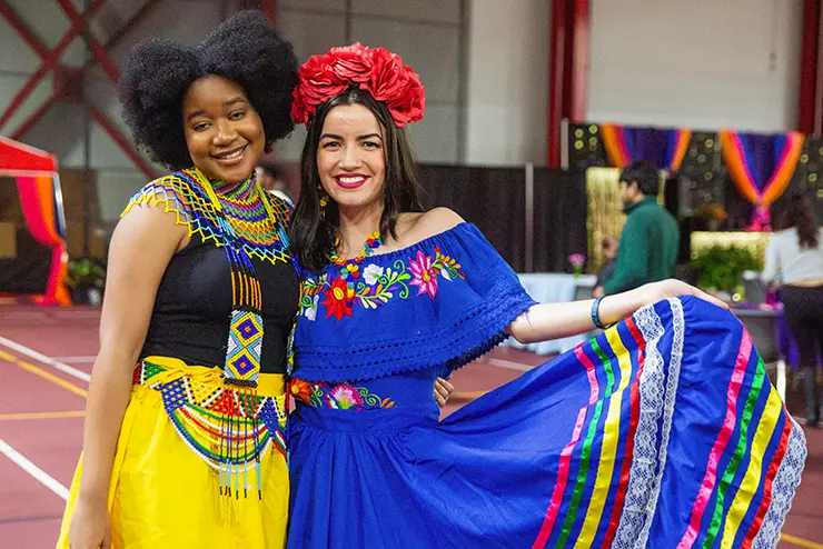 two SEMO students in their cultural garb pose together for a photo