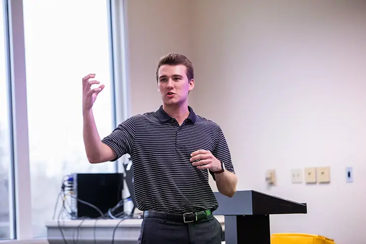 a SEMO student gestures as he gives a presentation