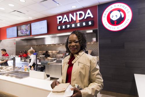 A student smiles after getting food at Panda Express.