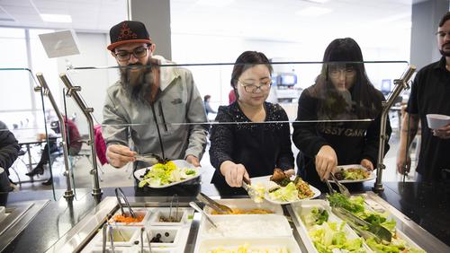 Students fill their plates at a salad bar in Towers Café.  