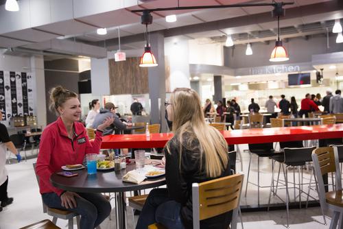Students talk while sharing a meal at Towers Café. 