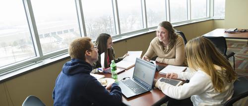 4 students in the Tomorrow's Teachers Learning Community study in a lounge at Laferla Hall. 