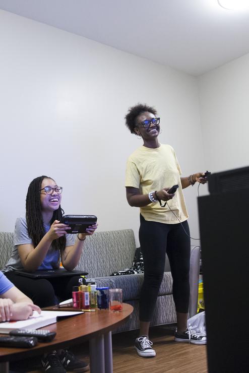 Students play a video game in their living room at the Dobbins River Campus Center. 
