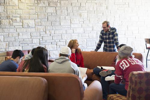 A study group meets in the Hearth room at Merick Hall. 