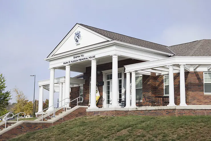 a view of the front of the Greek Village building