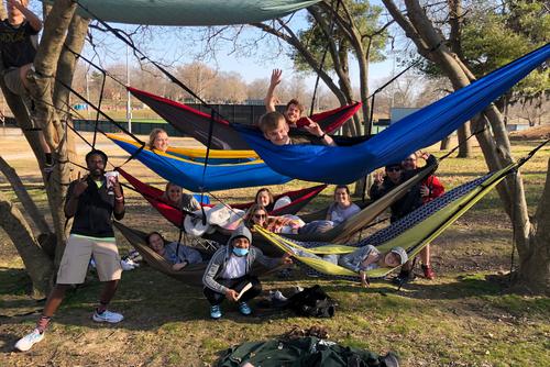 Alexandra and a group of friends active in greek life hang out in hammocks at Capaha Park.