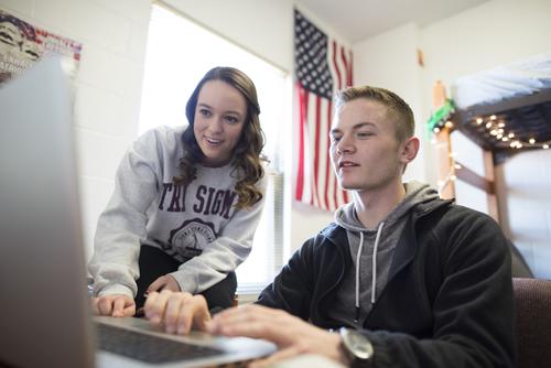 Residents watch a video on a laptop in a dorm room in Towers East.