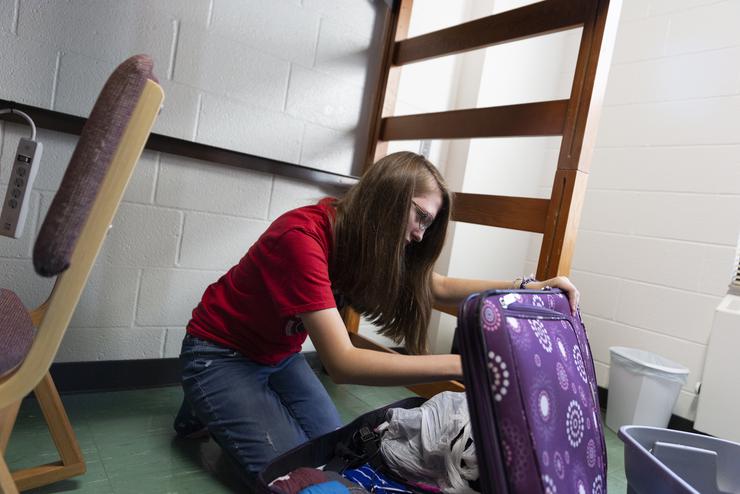 A Towers resident packs her final belongings into a suitcase as she prepares to move out of her dorm for the summer.
