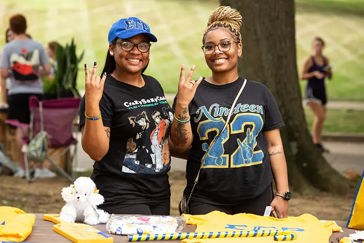 two members of a greek student organization pose for the camera