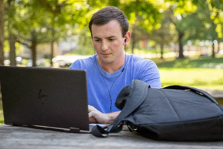 A student at SEMO studying outside becuase he's on campus and gets to enjoy the great spaces 