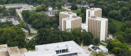 An aerial view of the Towers Complex featuring the scenic greenery in the summer around the campus dorms.