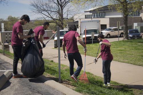A diverse group of students clean up the lawn areas of Southeast’s campus.