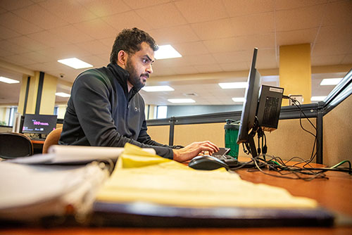 A student works on a Kent Library computer.