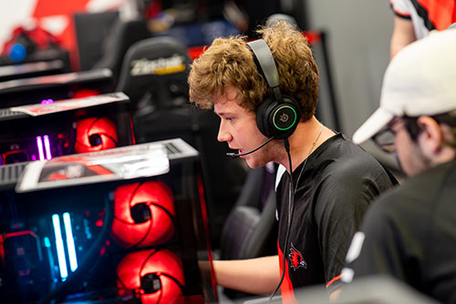 One of the Esports team plays a game with headphones on at the Arena.