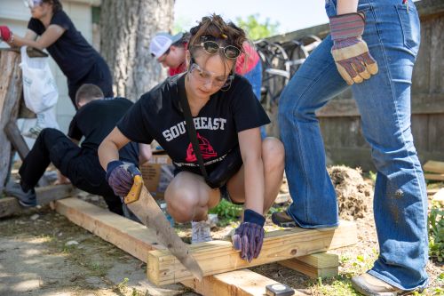 A Southeast student works on a board during the historic preservation field trip.
