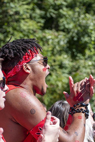 a fan in the SEMO student section wearing face pant claps and cheers