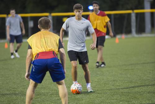 A student plays soccer on the Bertling intramural fields. 