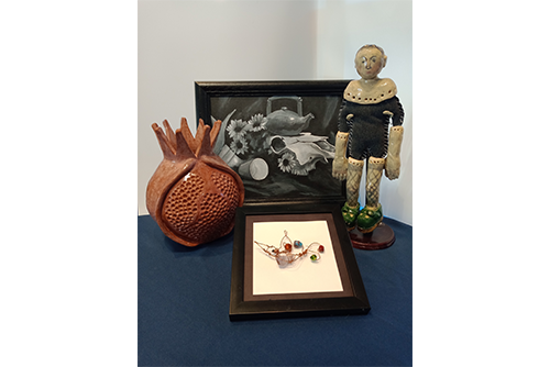 Image of a ceramic doll and a black and white drawing or picture of a teapot.