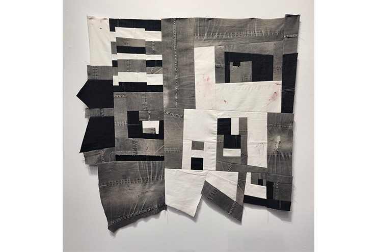 black and white picture of jean fabrics stitched together.