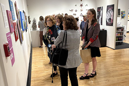Image taken by Jim Phillips of friends and family enjoying the art exhibit.