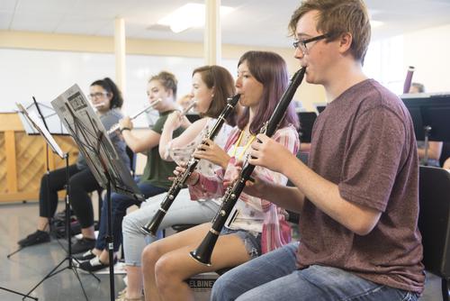 A group of musicians attending Orchestra Camp practice together.