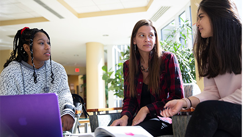 Image of three Southeast students talking.